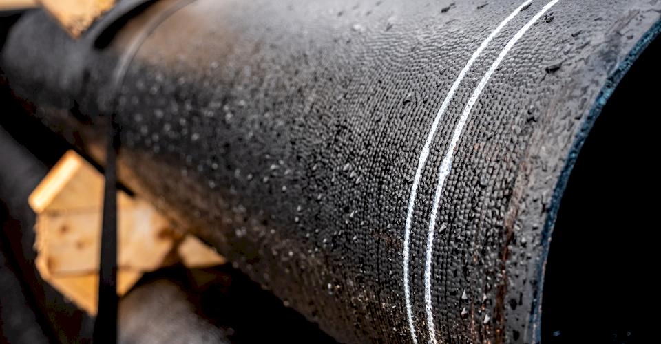 Rain drops on ductile on pipe.