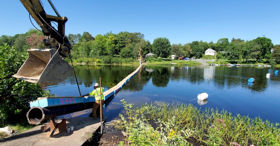 The pipeline makes a controlled float across the river as it's assembled.