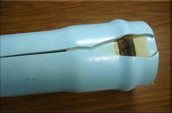 PVC pipe that has been over-belled, resulting in splitting.