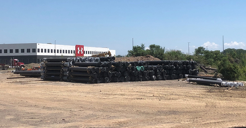 A stack of Ductile iron pipe awaits installation.