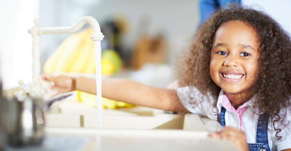 Drawing water from a tap.