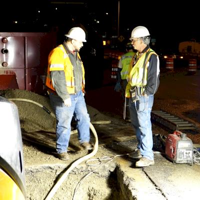 Contractor and Leak Detection Specialist discussing the plan.