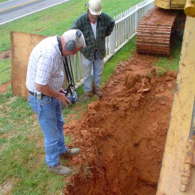 An experienced Leak Detection Specialist listens for a water leak.