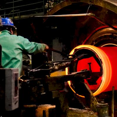 A 36-inch Ductile iron pipe glows red hot as it is cast.