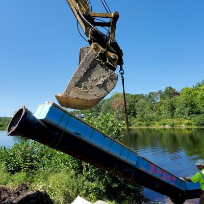 DI pipe is put in place during a river crossing in Milo, Maine.