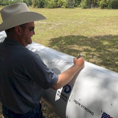 Partners of the project celebrated by signing a stick of pipe during a barbeque.