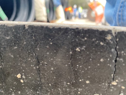 Close-up of longitudinal cracking of cement lining.