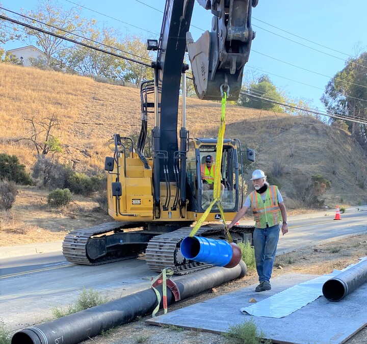 Bert Weiss guides the Seismic Flex Coupling in place.
